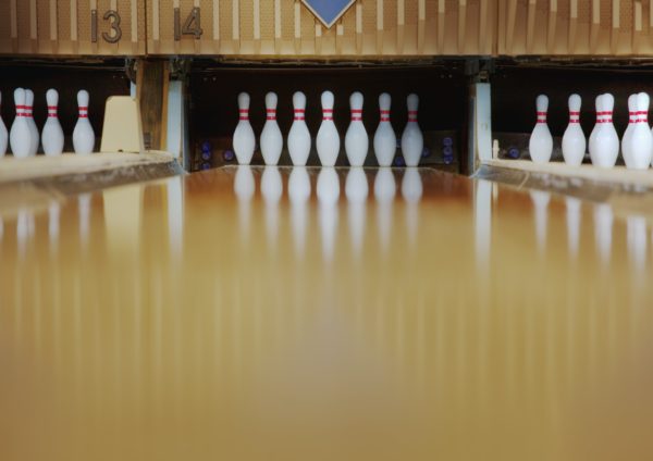 Bowling pins reflecting in bowling alley lane